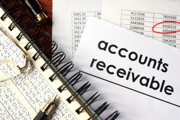 Open book and papers with accounting figures