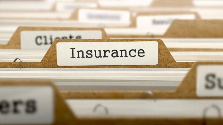 Brown file folders with Insurance written on the centered label