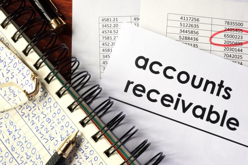 Open book and papers with accounting figures