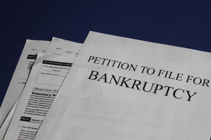 Petition to file banruptcy paperwork on blue background